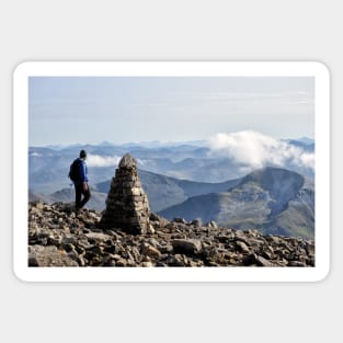 Climber passes a cairn on the summit of Ben Nevis Sticker